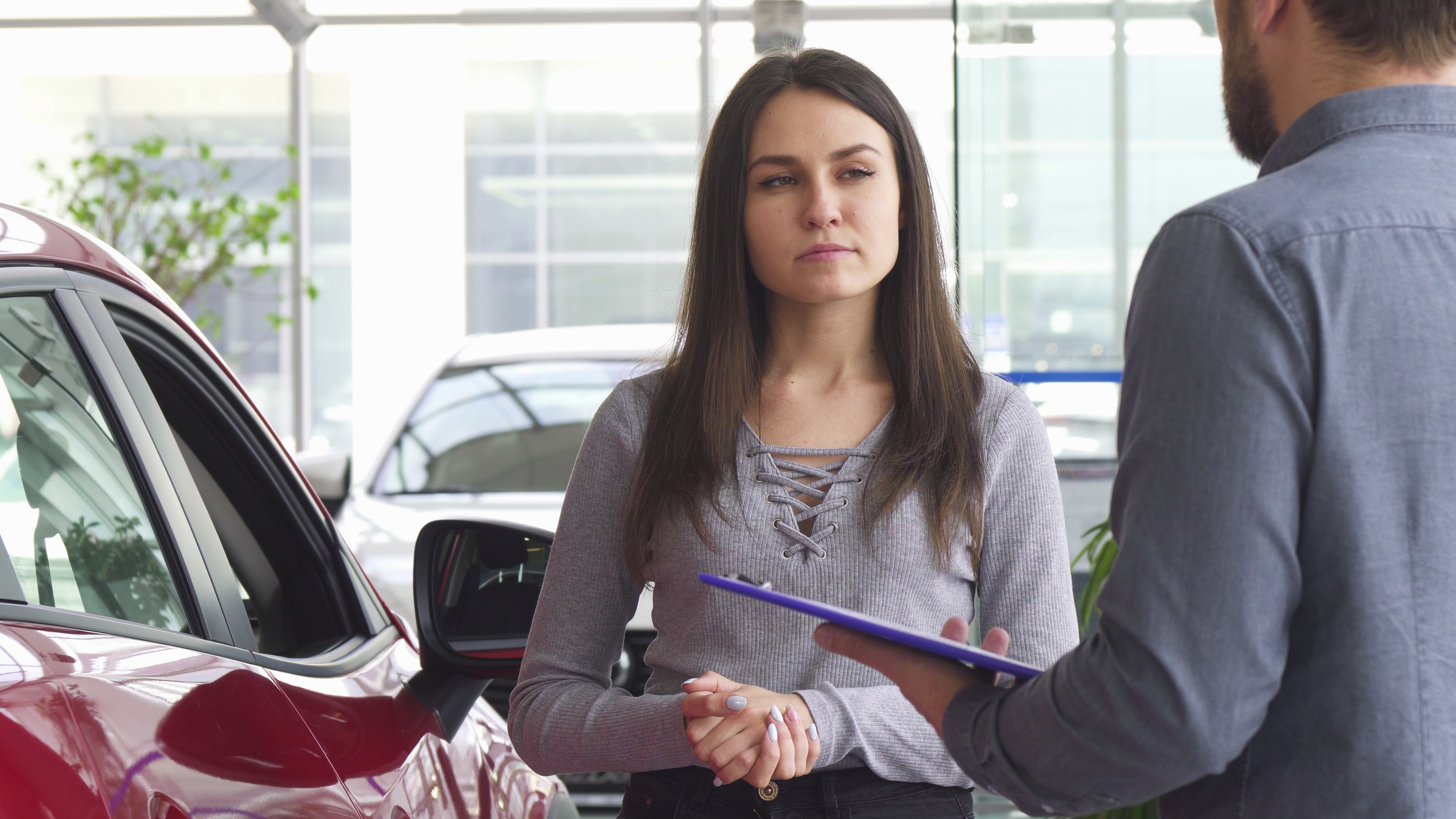 Buyer discussing a car ownership transfer at a dealership