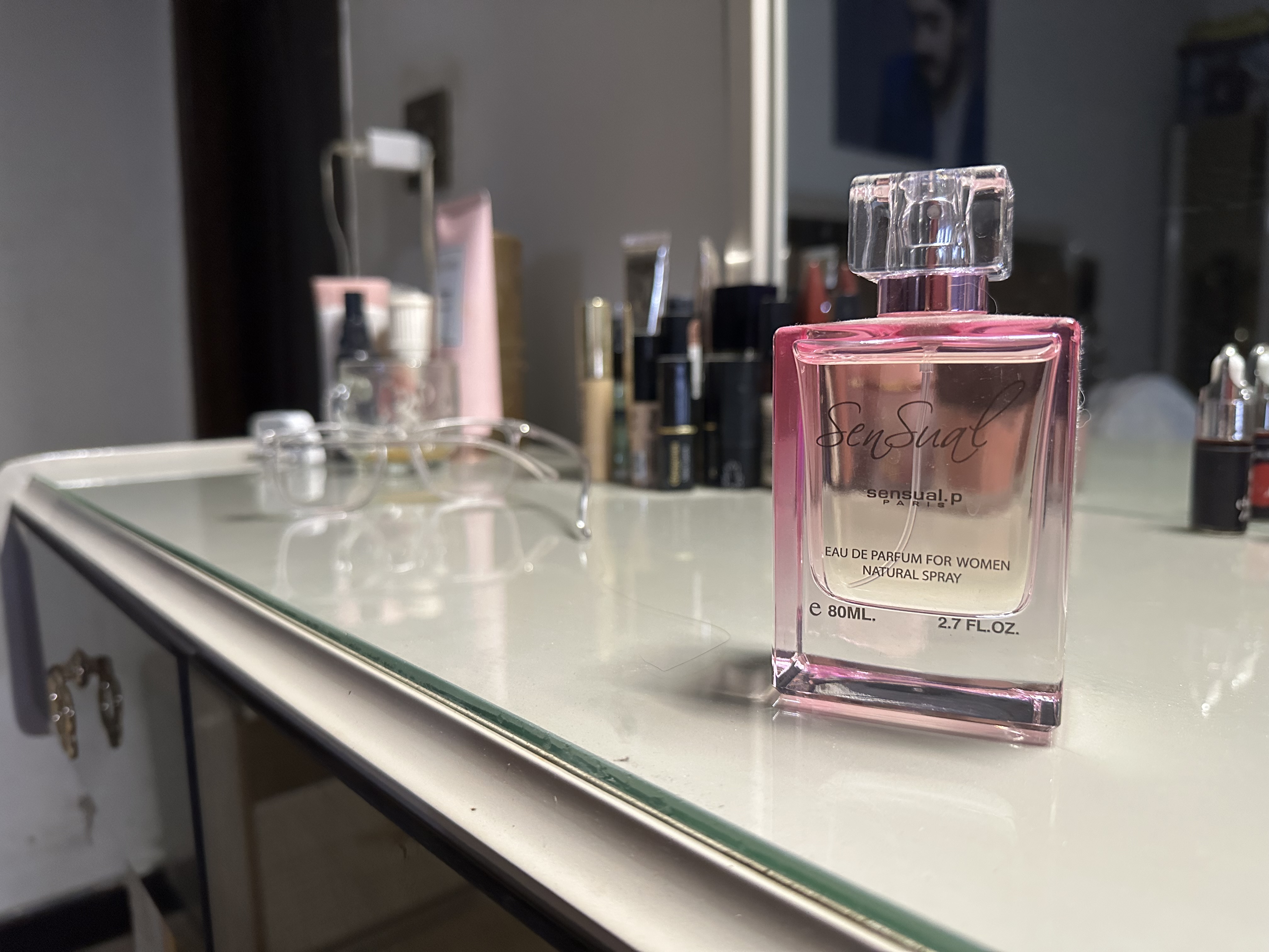 Pink perfume bottle on a dressing table
